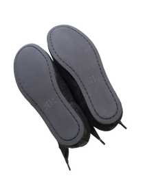Pair of black K-Two Studios Sash Flats shown from below with smooth sole and minimalist design.