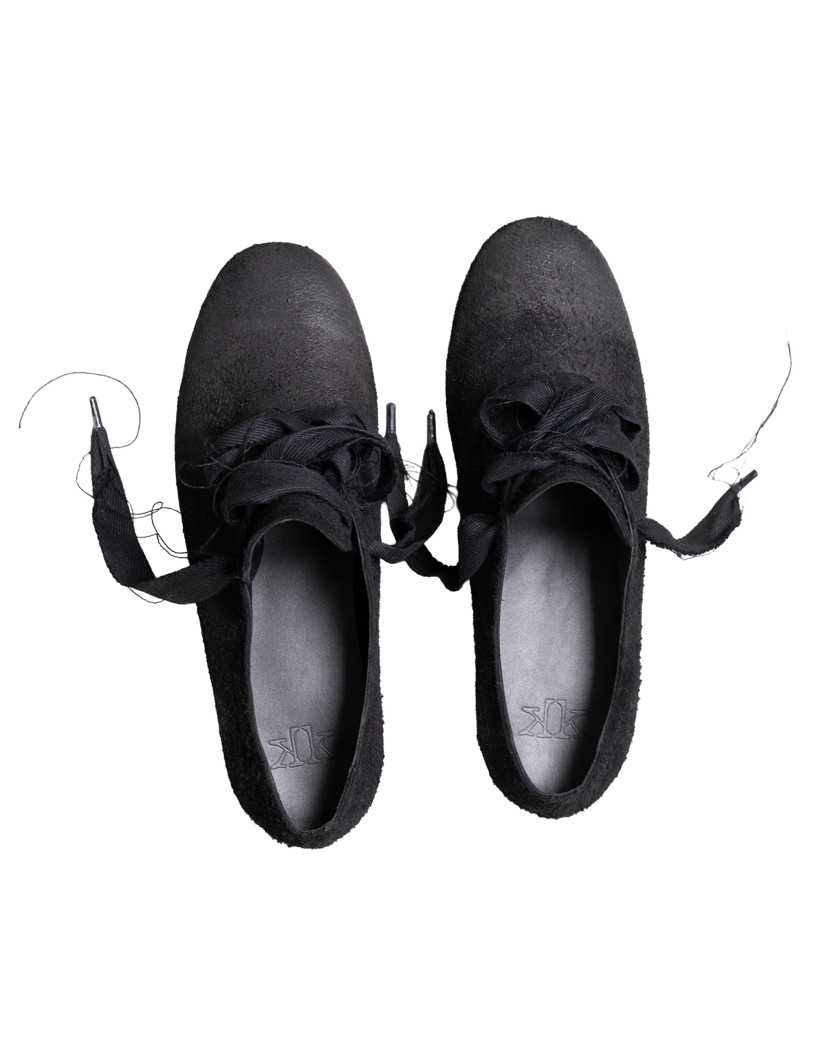 A pair of black suede lace-up shoes shown from a top-down view on a plain white background.