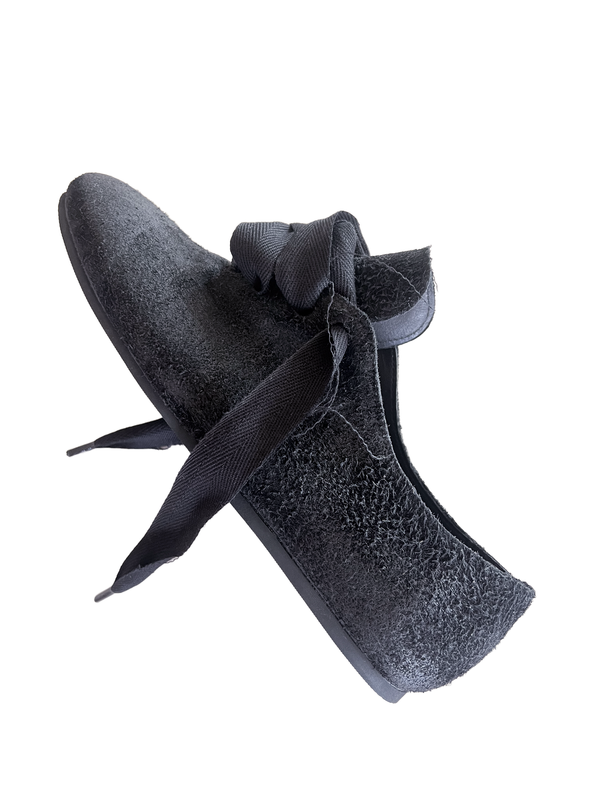 Side view of a black K-Two Studios Sash Flat with pointed sculptural shape and tied sash detail.